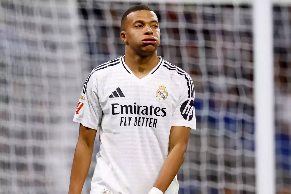 A soccer player in the white uniform of Real Madrid on the field. A soccer player in the white uniform of Real Madrid on the field.
