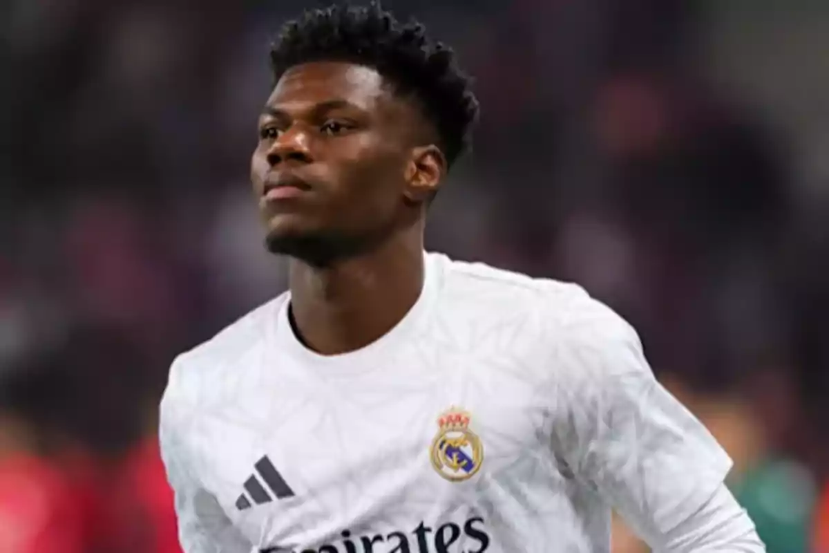 Football player in a white Real Madrid jersey on the field. Football player in a white Real Madrid jersey on the field.