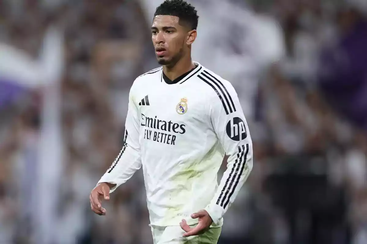 A soccer player in a white Real Madrid uniform on the field. A soccer player in a white Real Madrid uniform on the field.