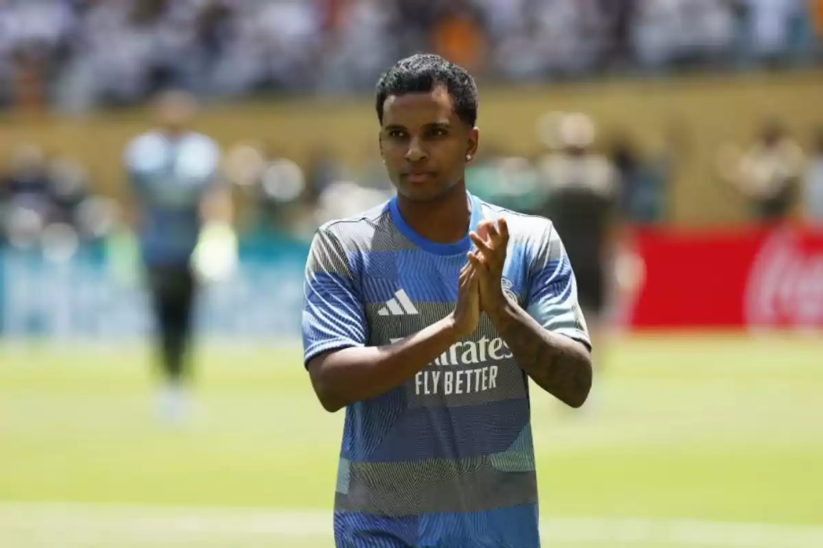 Soccer player in a blue uniform applauding on the field during a match Soccer player in a blue uniform applauding on the field during a match