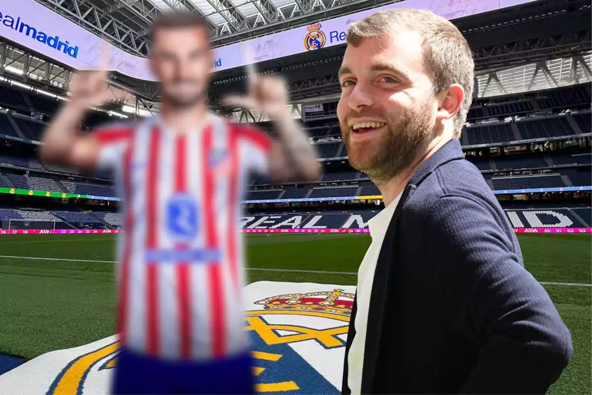 A smiling man in the foreground inside a soccer stadium with the Real Madrid logo on the field and a blurred figure in a red and white striped jersey in the background