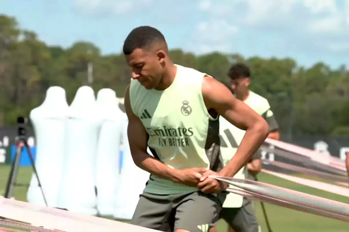 Futbolista entrenando con bandas elásticas en un campo al aire libre