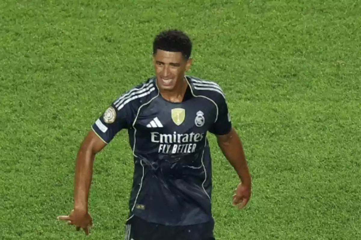 Soccer player in a dark Real Madrid uniform celebrating on the field