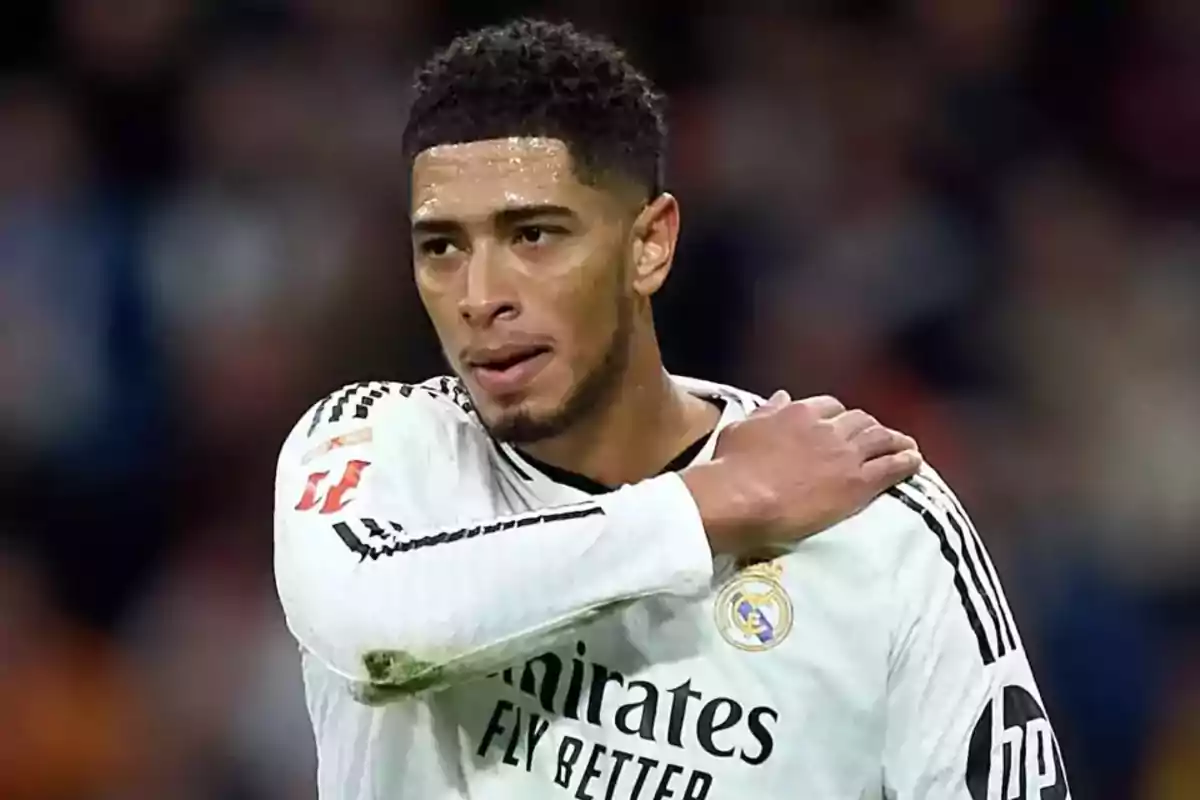 Real Madrid player in the white uniform touching his shoulder during a match Real Madrid player in the white uniform touching his shoulder during a match