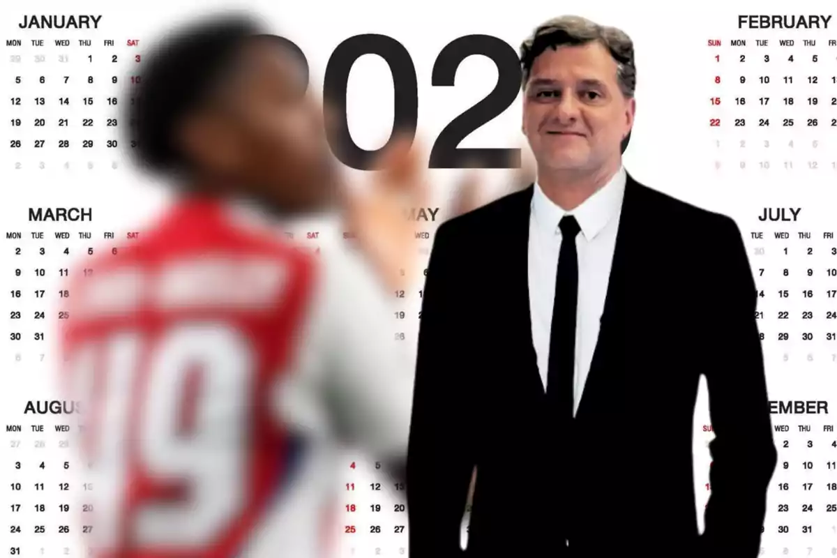 A man in a black suit and tie appears in front of a large calendar, while a person in a red and white sports jersey is blurred in the foreground.