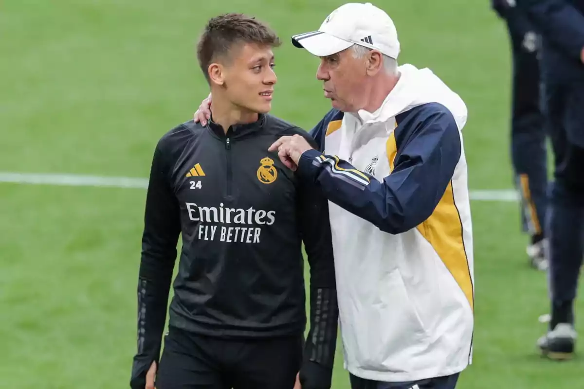 Real Madrid coach and player talking on the training field Real Madrid coach and player talking on the training field