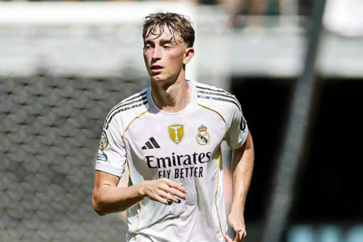 Soccer player in a white Real Madrid uniform running on the field during a match Soccer player in a white Real Madrid uniform running on the field during a match