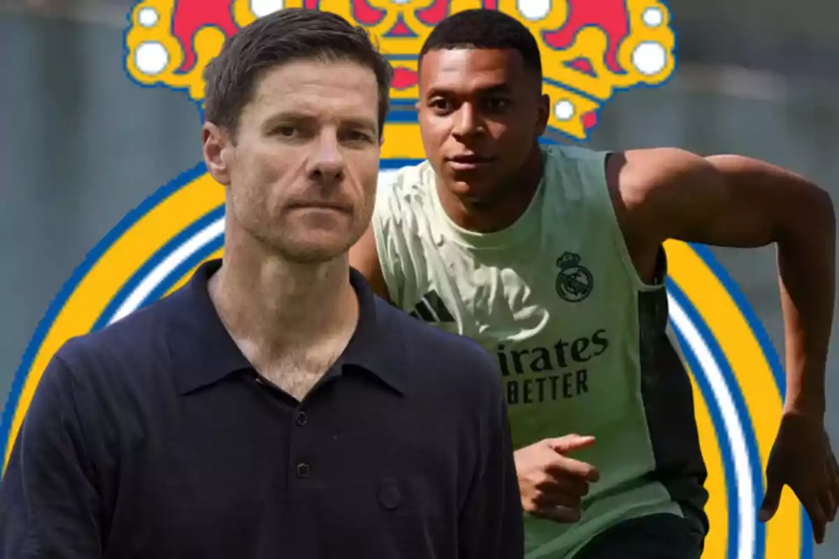 Two men in front of the Real Madrid crest, one wearing a training jersey and the other in a dark jersey.