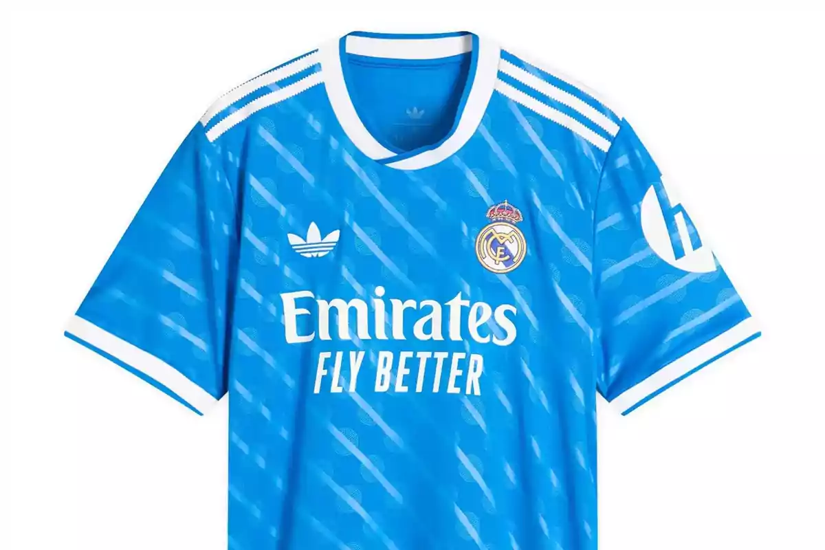 Blue Real Madrid jersey with white details and Adidas and Emirates Fly Better logos
