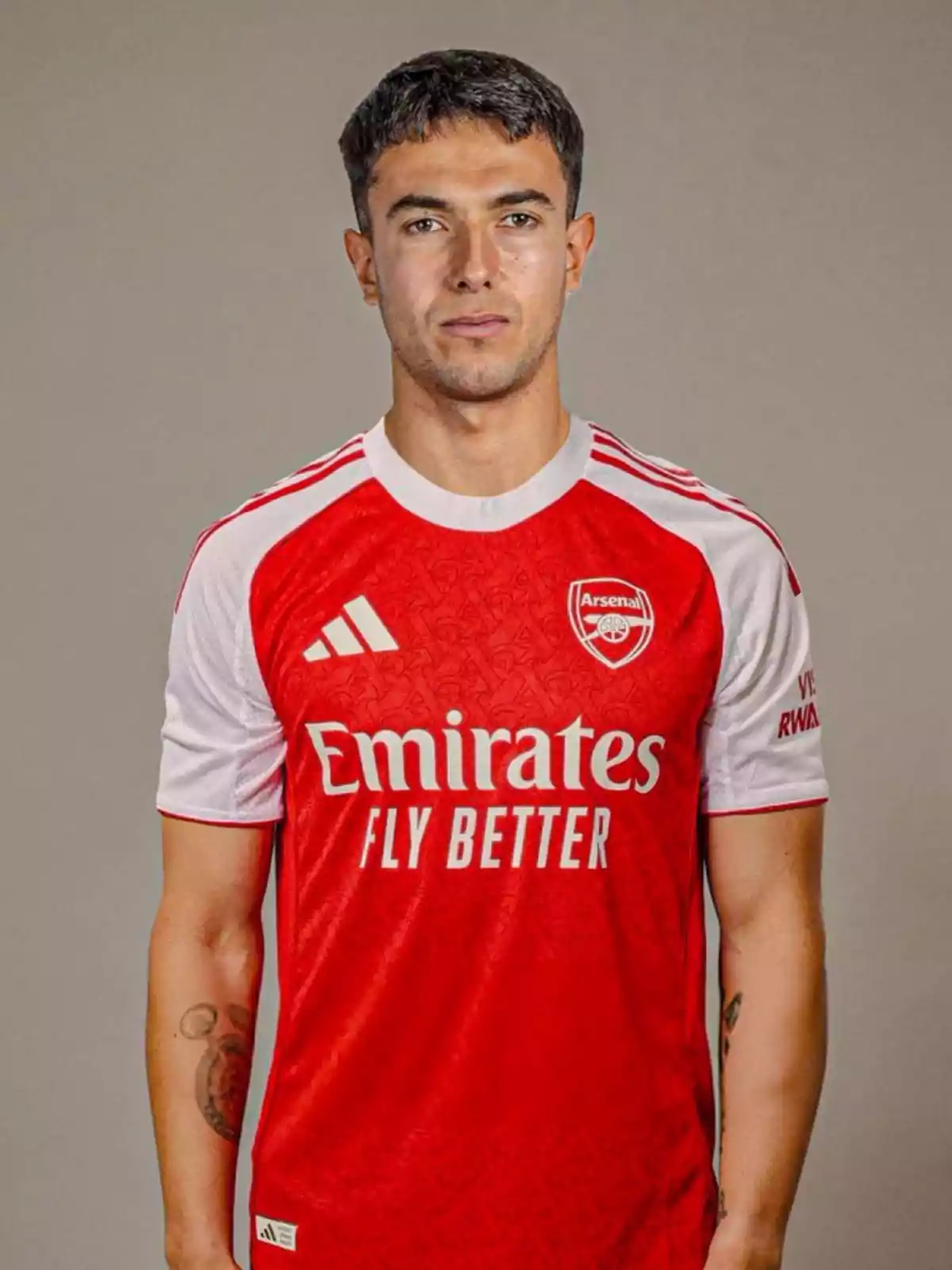 Soccer player posing in Arsenal’s red and white uniform Soccer player posing in Arsenal’s red and white uniform