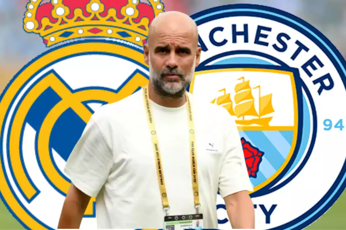 A bald man with a beard and a white t-jersey is standing in front of the Real Madrid and Manchester City crests.