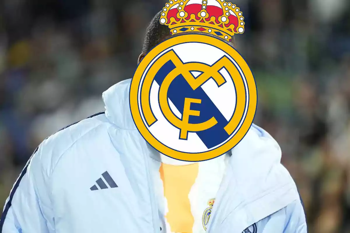 Person wearing a white sports jacket with the Real Madrid crest covering their face
