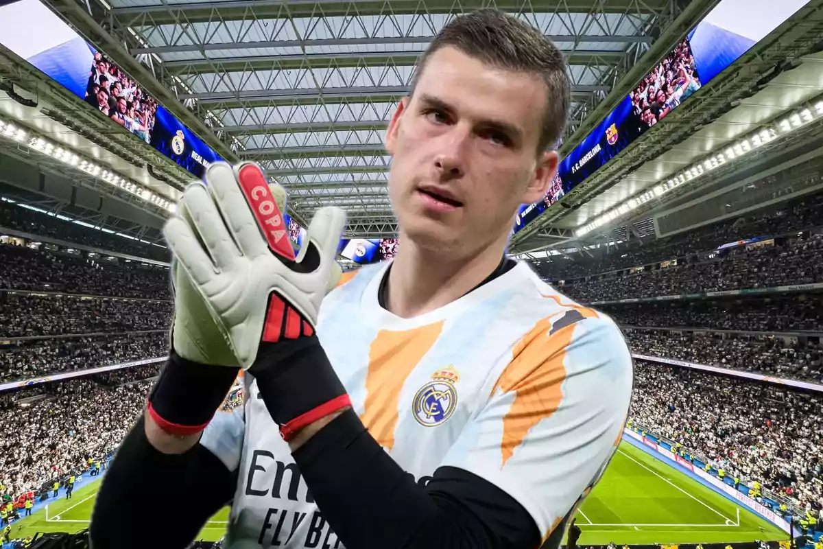 Goalkeeper wearing gloves and a Real Madrid uniform applauding in a stadium full of fans
