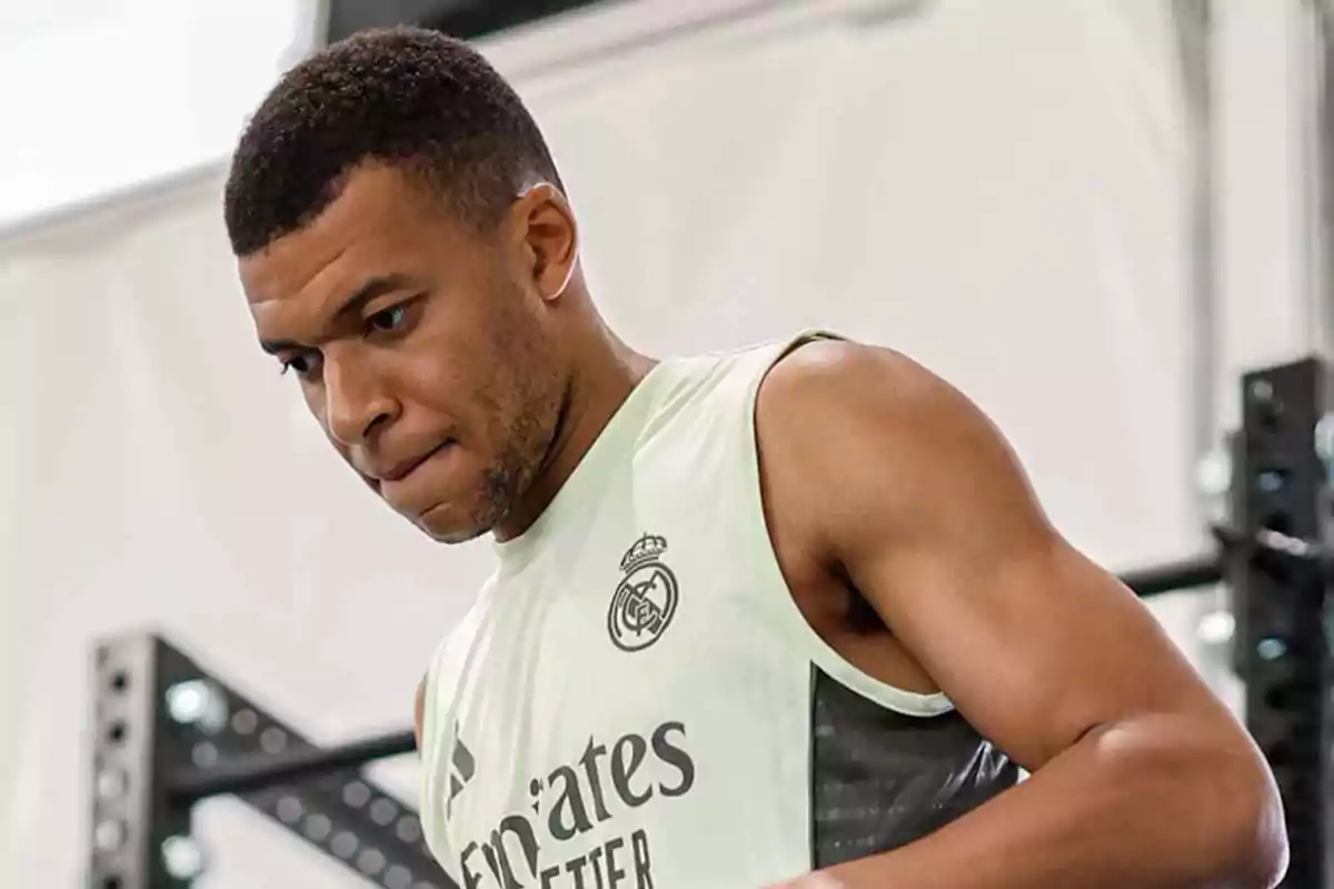 Soccer player training in a Real Madrid sleeveless jersey at a gym Soccer player training in a Real Madrid sleeveless jersey at a gym
