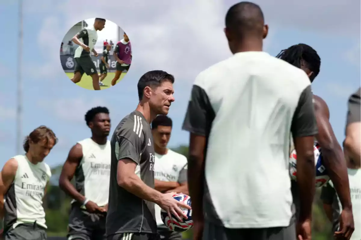Soccer coach giving instructions to players during an outdoor practice with a group of alert players and a ball in the coach’s hands; in the upper left corner, there is a box showing two players in action.