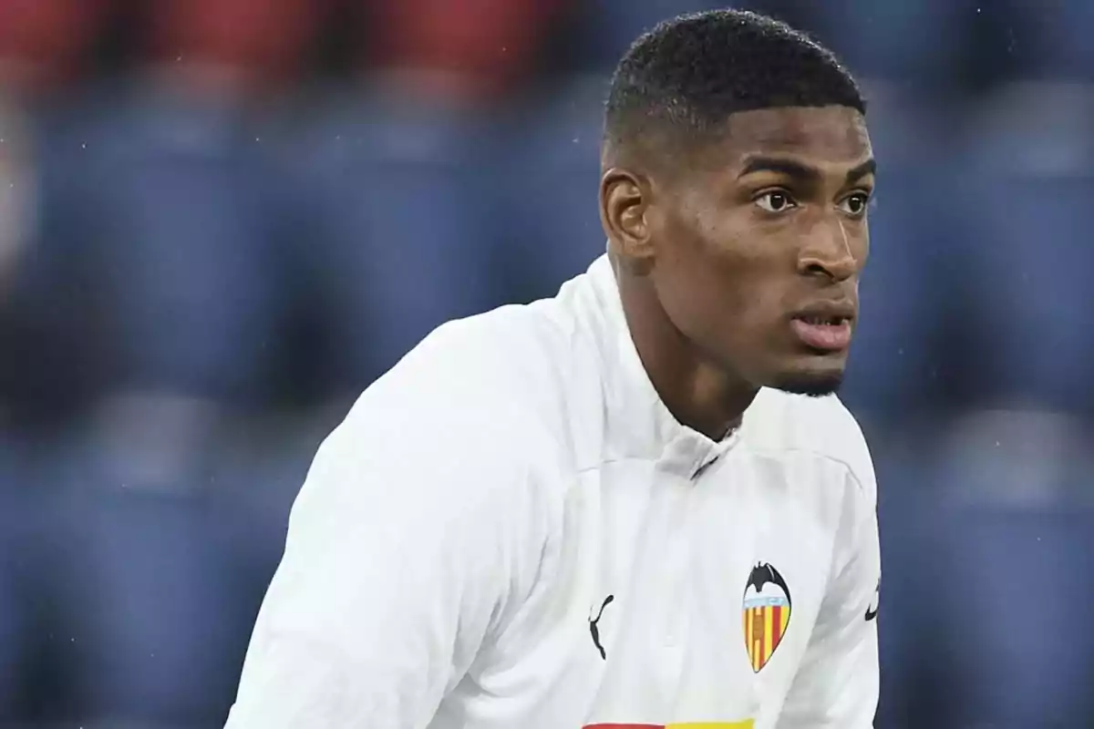 Soccer player in a white Valencia uniform in a stadium Soccer player in a white Valencia uniform in a stadium