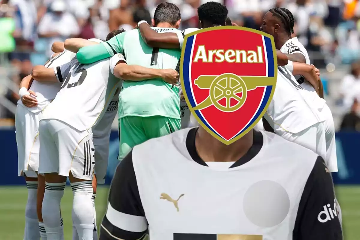 A group of players dressed in white are hugging on the field while a player in the foreground has the Arsenal badge covering his face.