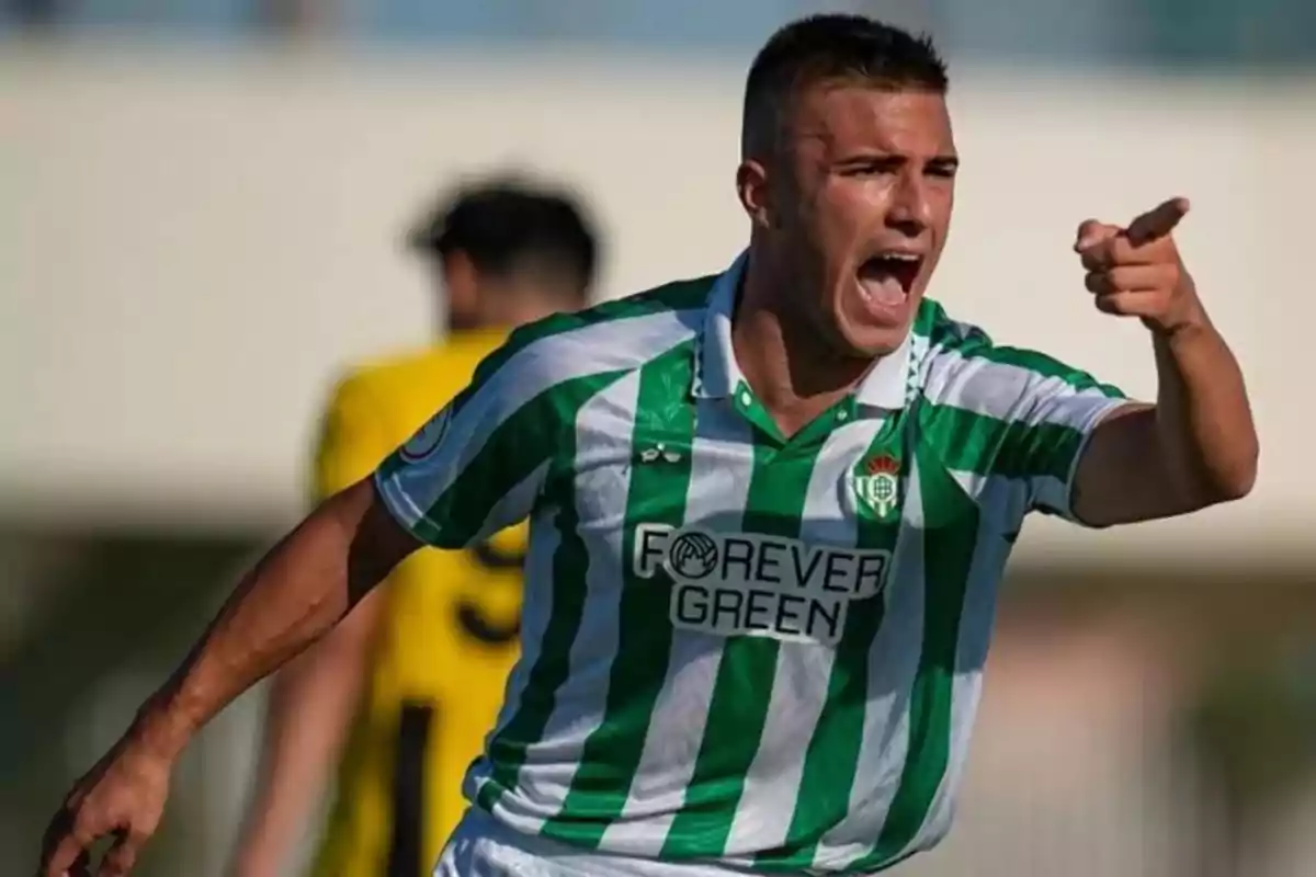 Soccer player in a green and white striped uniform celebrating enthusiastically and pointing with his finger during a match Soccer player in a green and white striped uniform celebrating enthusiastically and pointing with his finger during a match