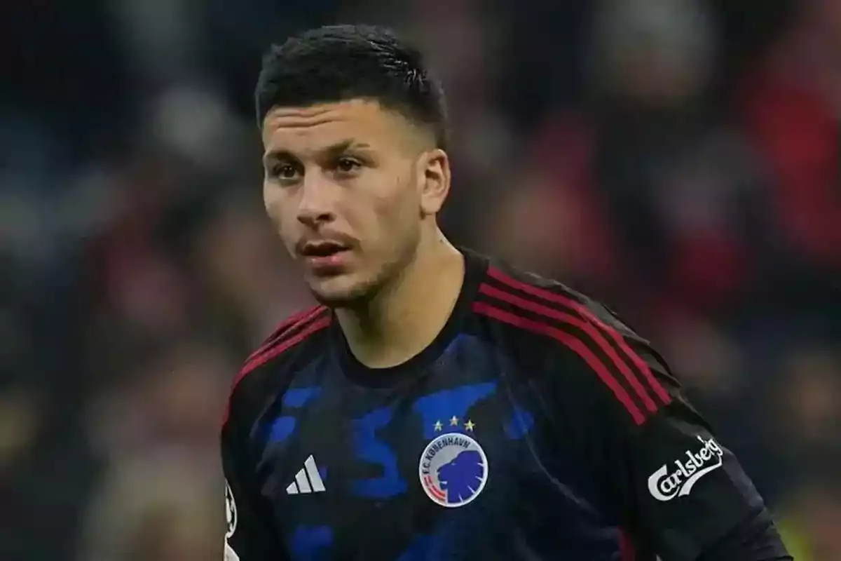 Soccer player wearing a black and blue FC Copenhagen uniform during a match Soccer player wearing a black and blue FC Copenhagen uniform during a match