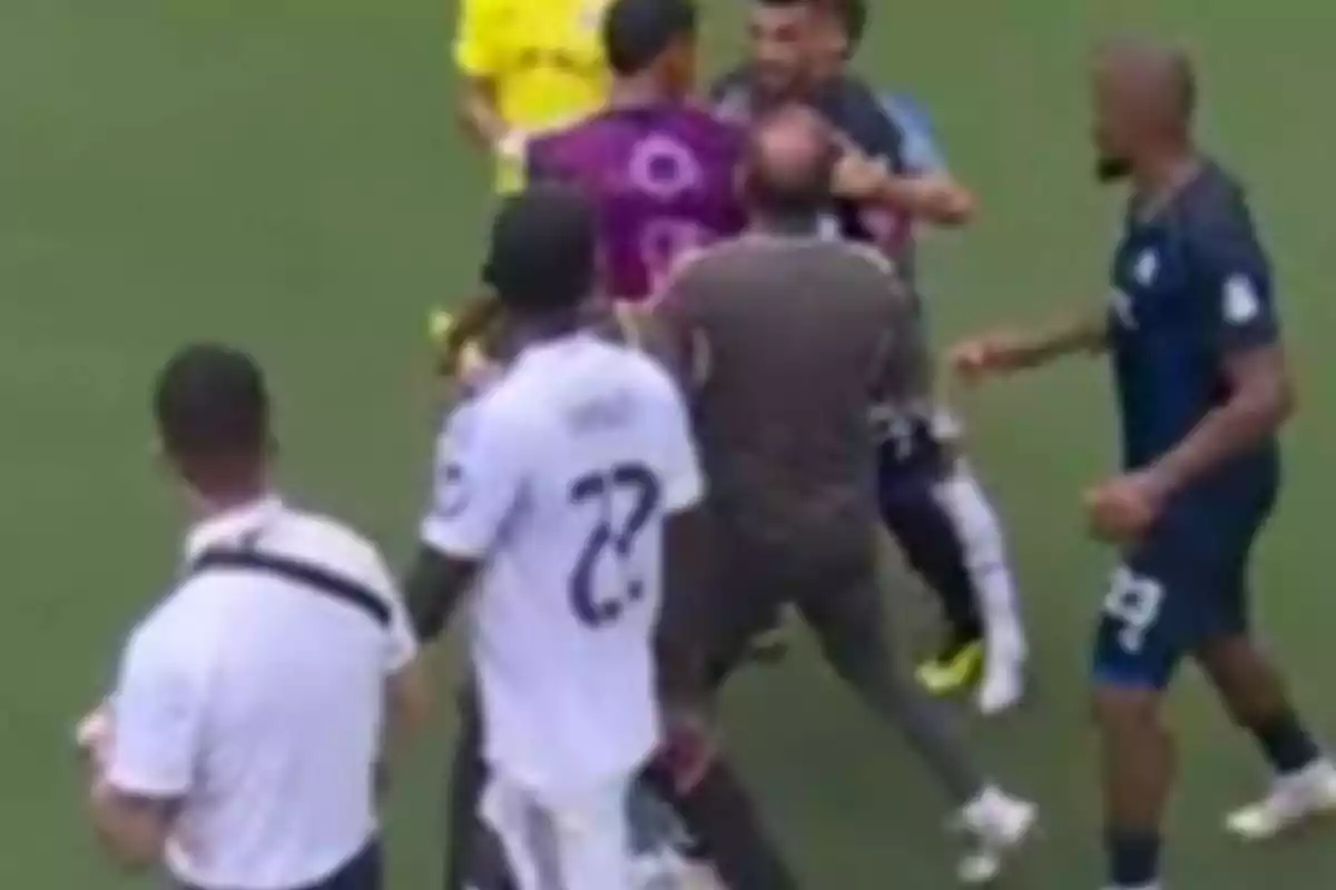 Several players and a referee argue on the soccer field during a match. Several players and a referee argue on the soccer field during a match.