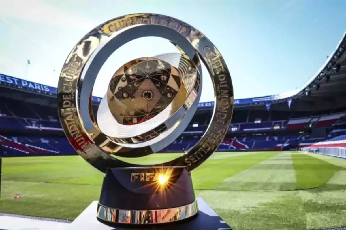 FIFA Club World Cup trophy on a black base in the center of an empty soccer stadium during the day FIFA Club World Cup trophy on a black base in the center of an empty soccer stadium during the day