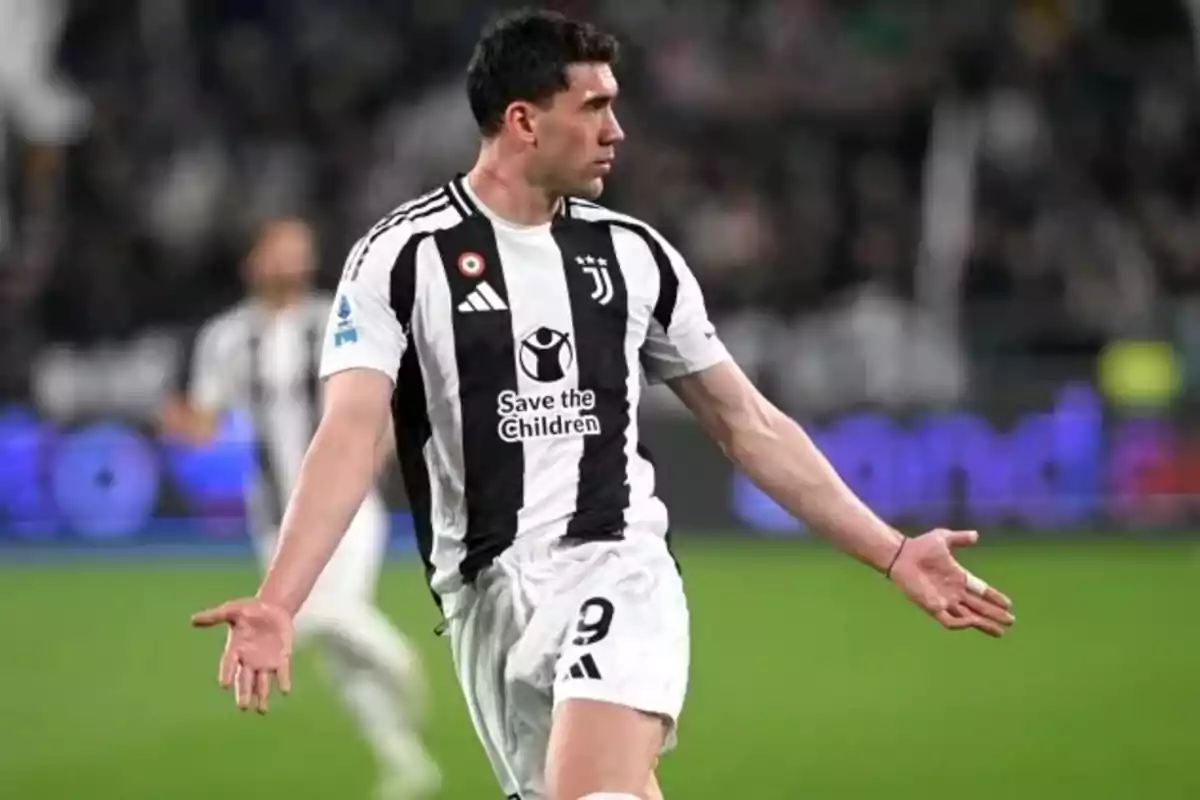 Juventus player celebrating a goal with arms outstretched in a stadium Juventus player celebrating a goal with arms outstretched in a stadium