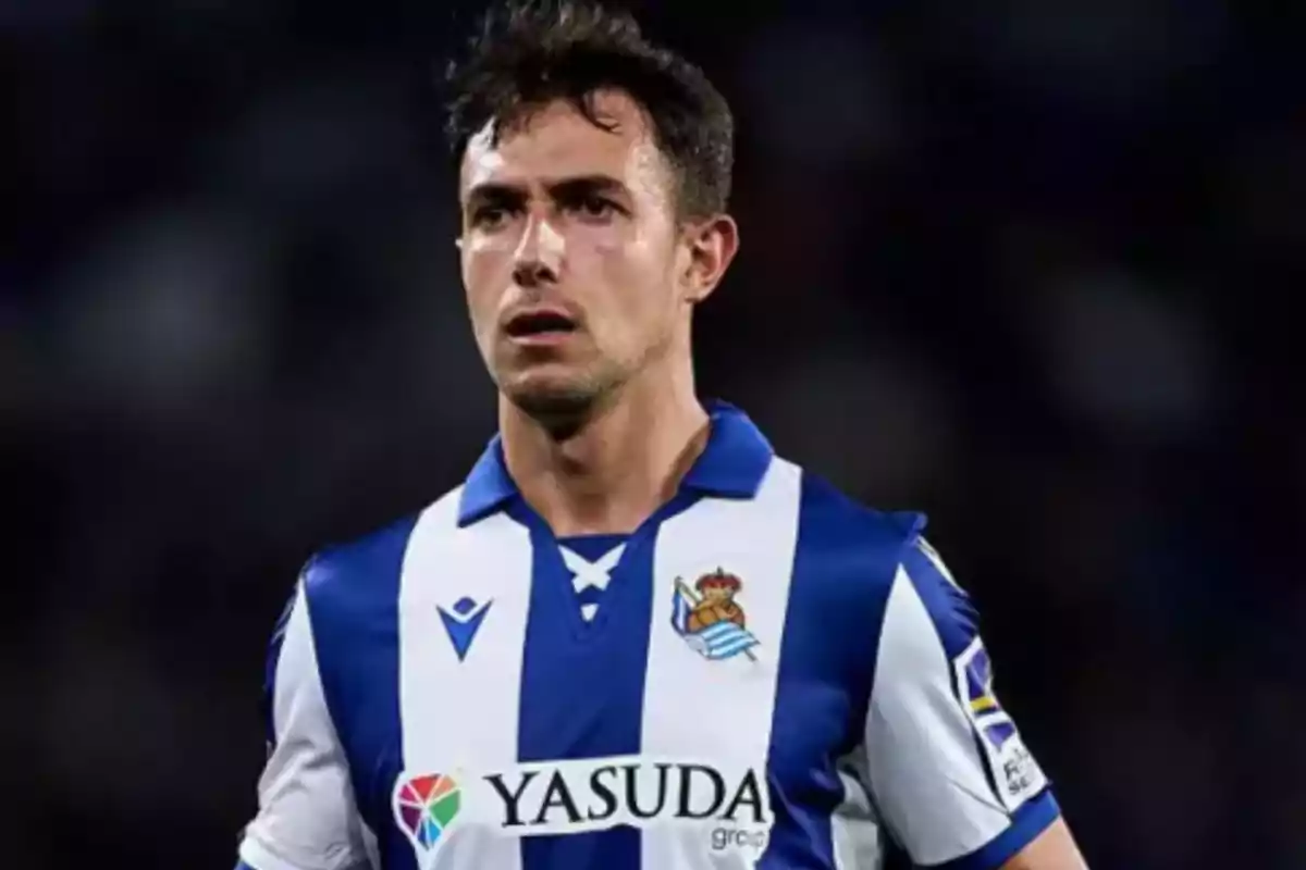 Soccer player wearing the blue and white uniform of Real Sociedad during a match Soccer player wearing the blue and white uniform of Real Sociedad during a match