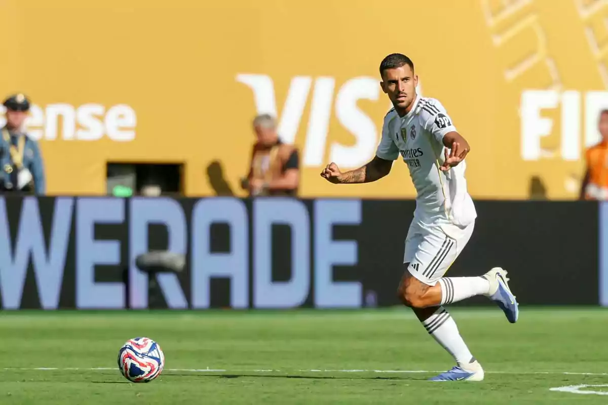 Real Madrid player about to kick a ball during a match in a stadium