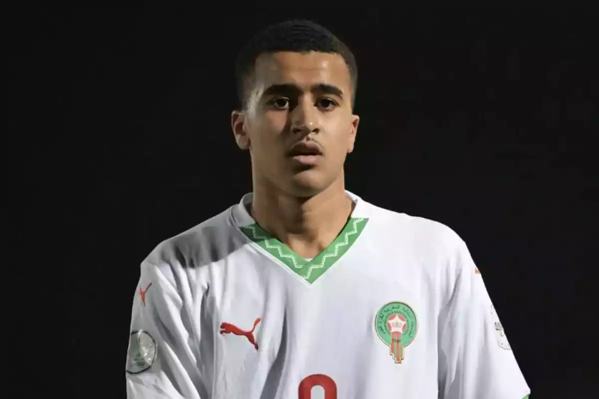 Joven futbolista con camiseta blanca de la selección de Marruecos sobre fondo negro