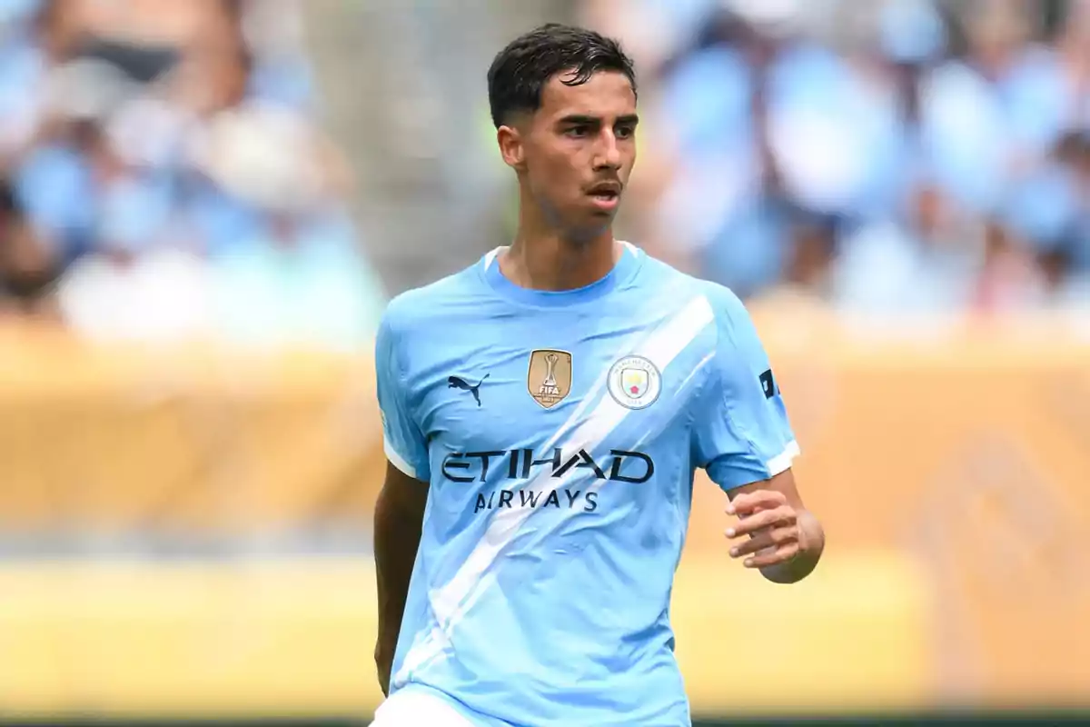 Soccer player in a light blue Manchester City uniform during a match Soccer player in a light blue Manchester City uniform during a match