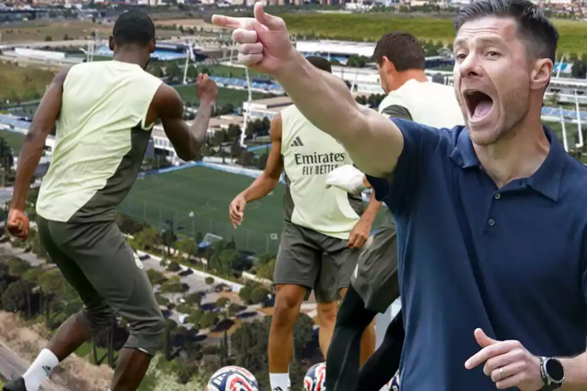 Soccer coach giving energetic instructions while several players train on an outdoor soccer field