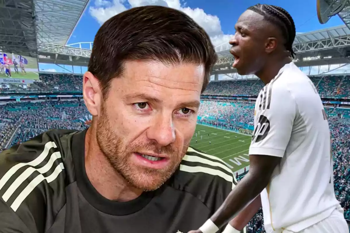 Two players wearing Real Madrid uniforms appear in the foreground inside a stadium full of fans.