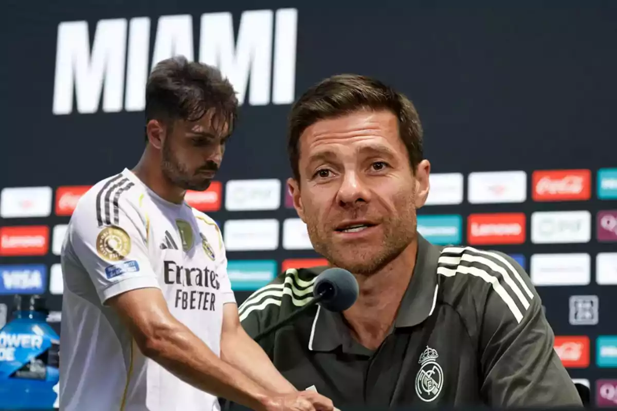 A Real Madrid coach gives a press conference while a team player appears thoughtful in the background with the word Miami on the stage.