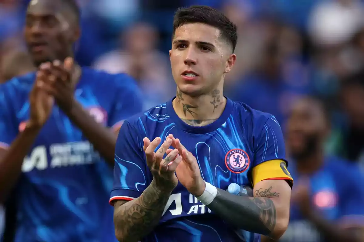 Chelsea footballer applauding on the field wearing a blue uniform and captain's armband Chelsea footballer applauding on the field wearing a blue uniform and captain's armband