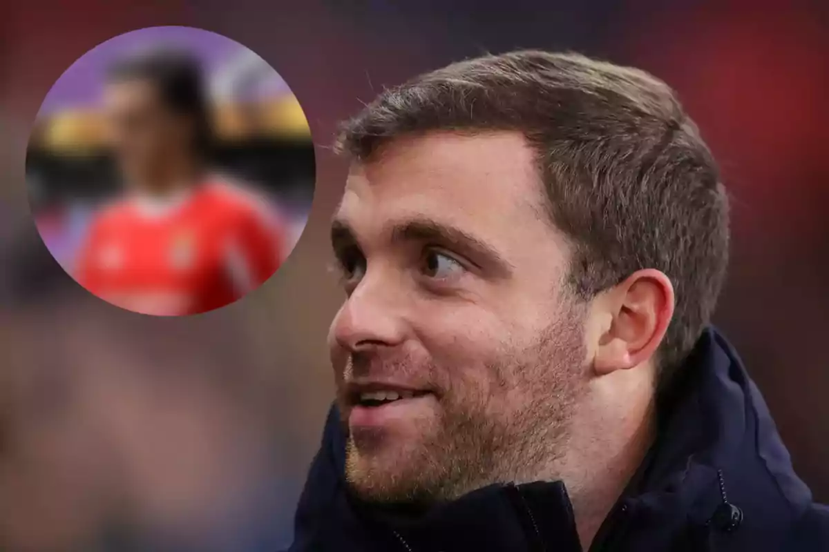 Short-haired man with a light beard looking to the left, with a blurred person in the background inside a circle.