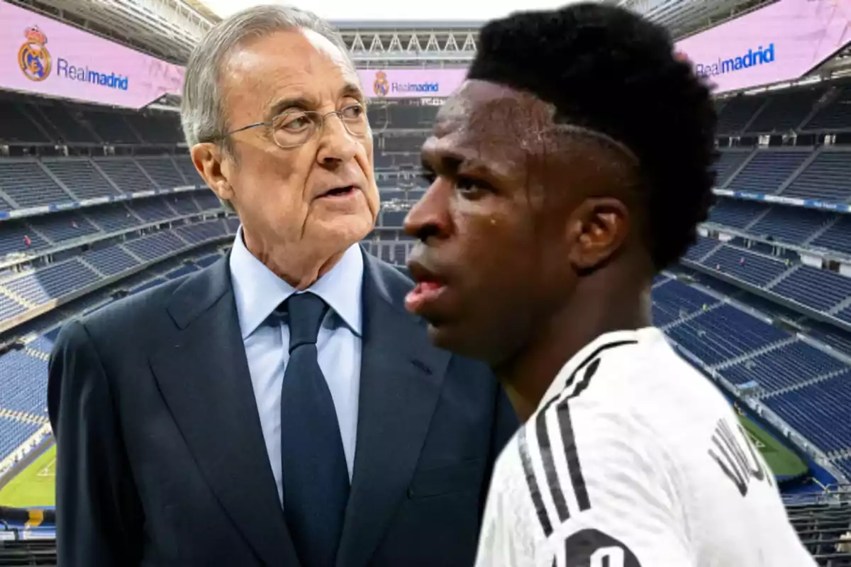 A man in a suit and a player in a white uniform are in an empty Real Madrid stadium.