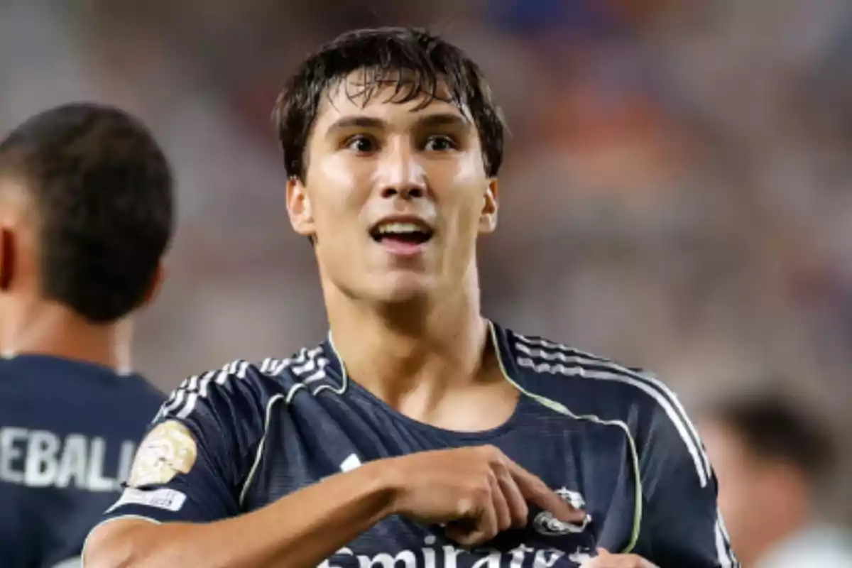 Soccer player in a dark jersey celebrating during a match Soccer player in a dark jersey celebrating during a match