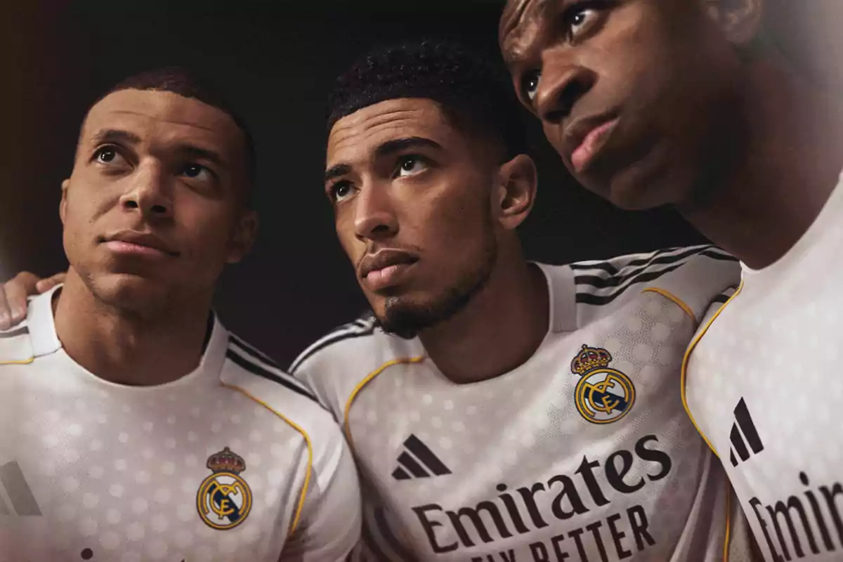 Three players wearing Real Madrid’s white jersey pose together, looking up with serious and focused expressions. Three players wearing Real Madrid’s white jersey pose together, looking up with serious and focused expressions.
