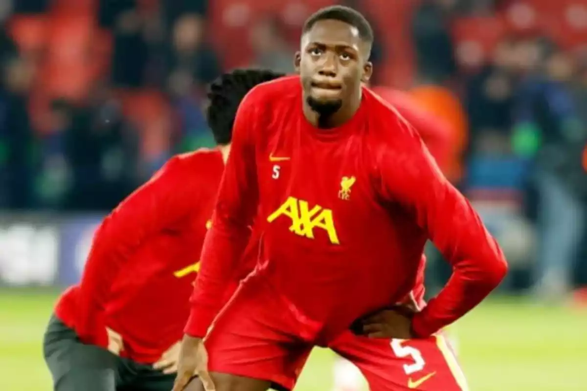 Liverpool player in a red uniform warming up on the field before a match Liverpool player in a red uniform warming up on the field before a match