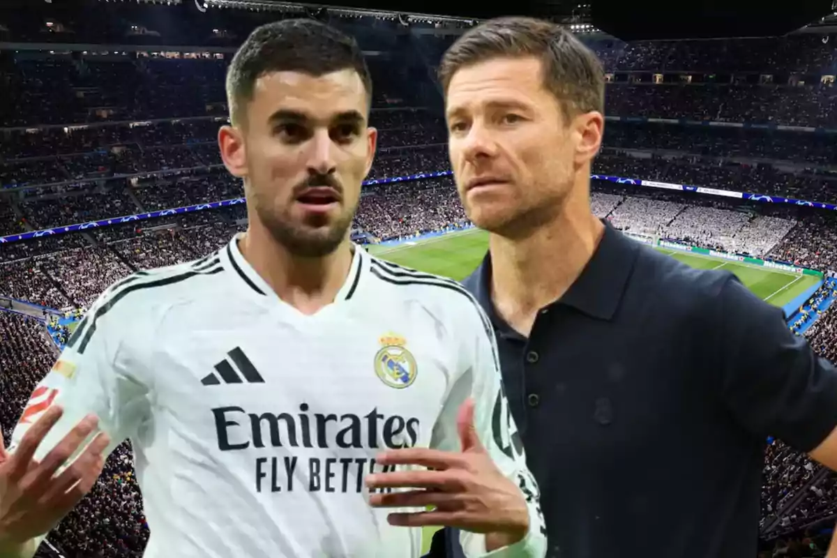 Two men in a soccer stadium, one wearing a white Real Madrid uniform and the other wearing a dark jersey