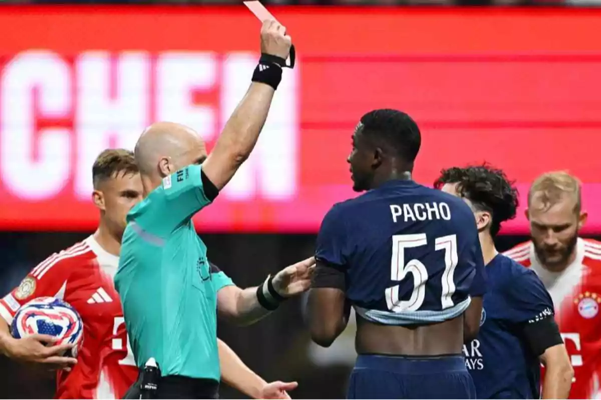 Referee showing a red card to a player during a soccer match while other players watch the scene Referee showing a red card to a player during a soccer match while other players watch the scene