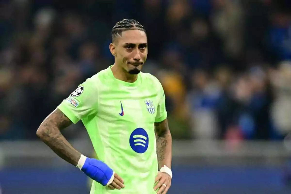 Soccer player in a neon green Barcelona uniform on the field with a serious expression and hands on their waist Soccer player in a neon green Barcelona uniform on the field with a serious expression and hands on their waist