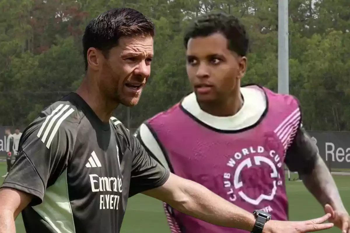 Soccer coach giving instructions to a player during a training session on an outdoor field