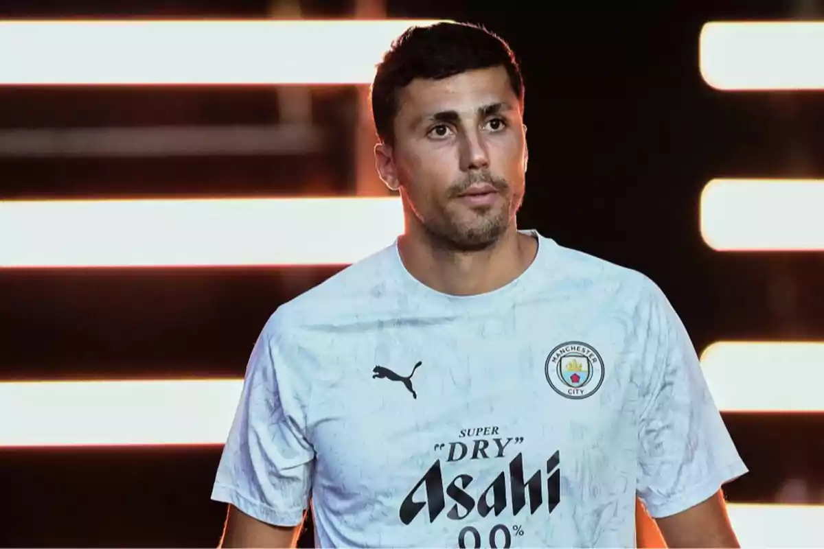 Soccer player wearing a white Manchester City jersey with a dark background and bright horizontal lights Soccer player wearing a white Manchester City jersey with a dark background and bright horizontal lights