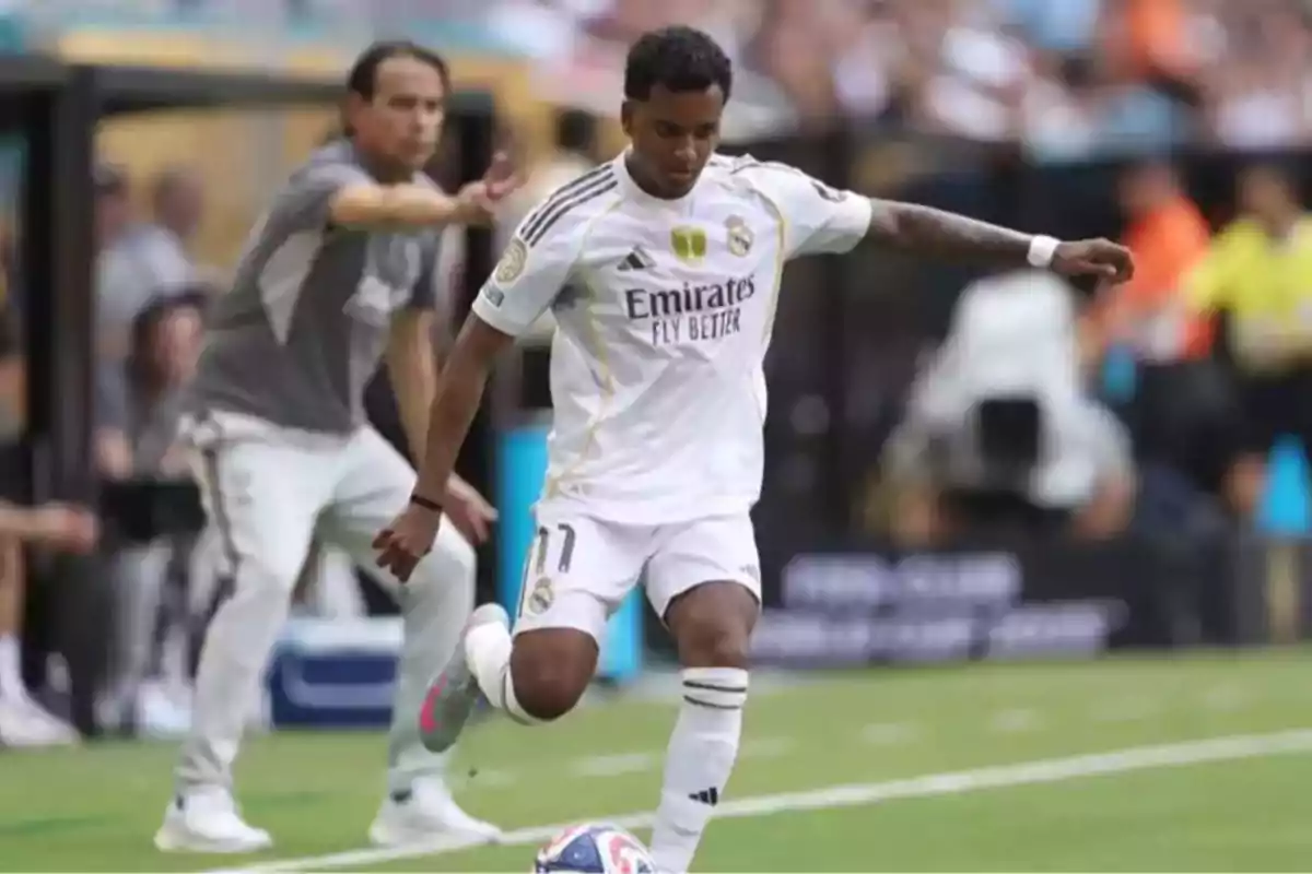 Real Madrid player controlling the ball during a match with a coach giving instructions in the background Real Madrid player controlling the ball during a match with a coach giving instructions in the background