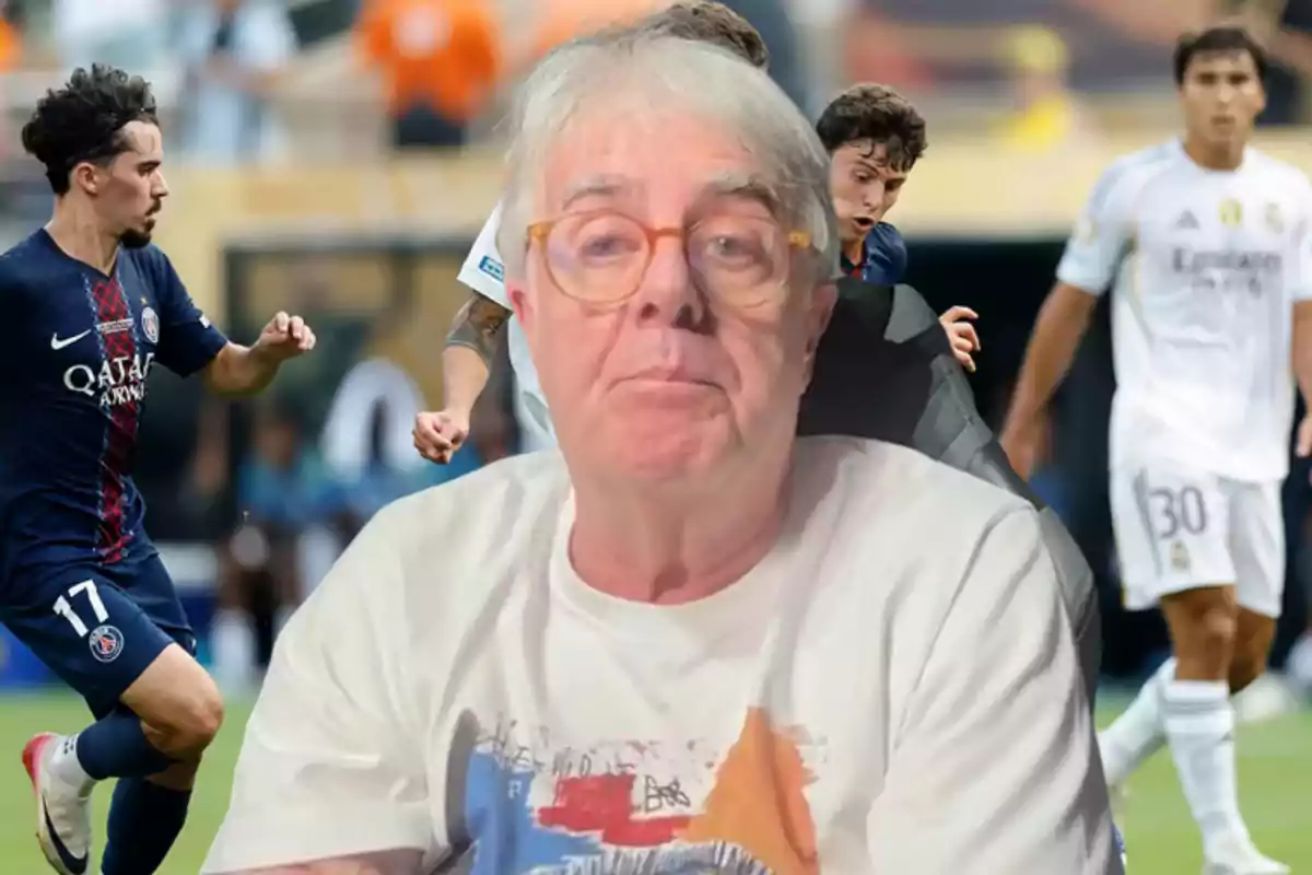 Gray-haired man with glasses in the foreground with a background of players in action