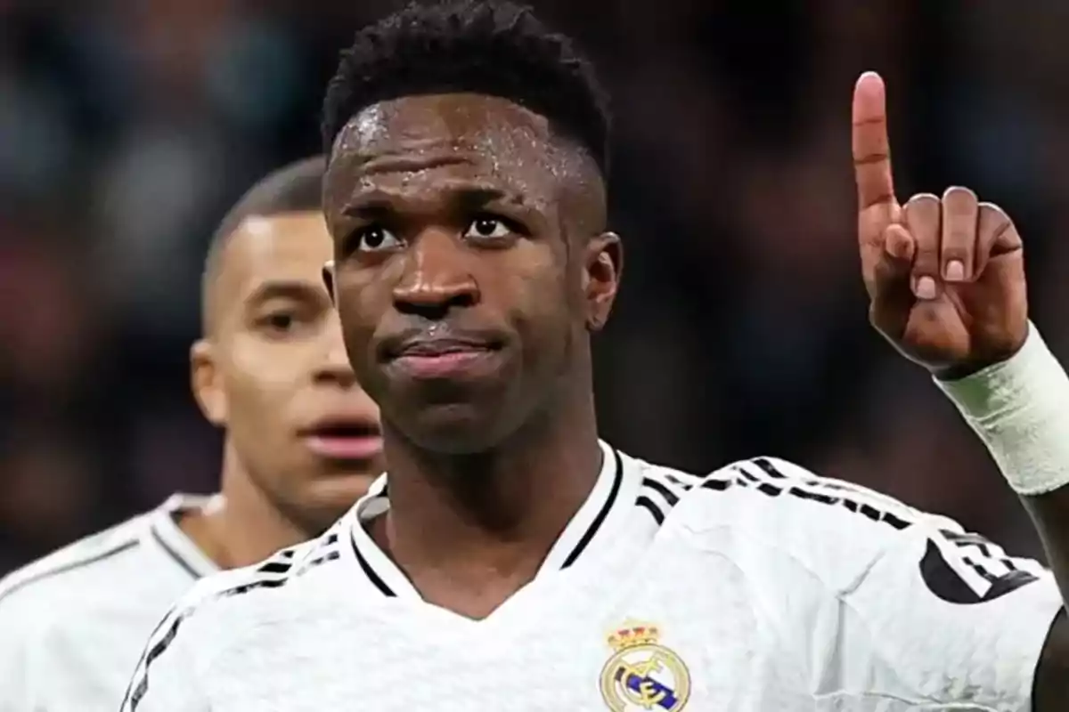 Soccer player in a white uniform raising one finger while on the field Soccer player in a white uniform raising one finger while on the field
