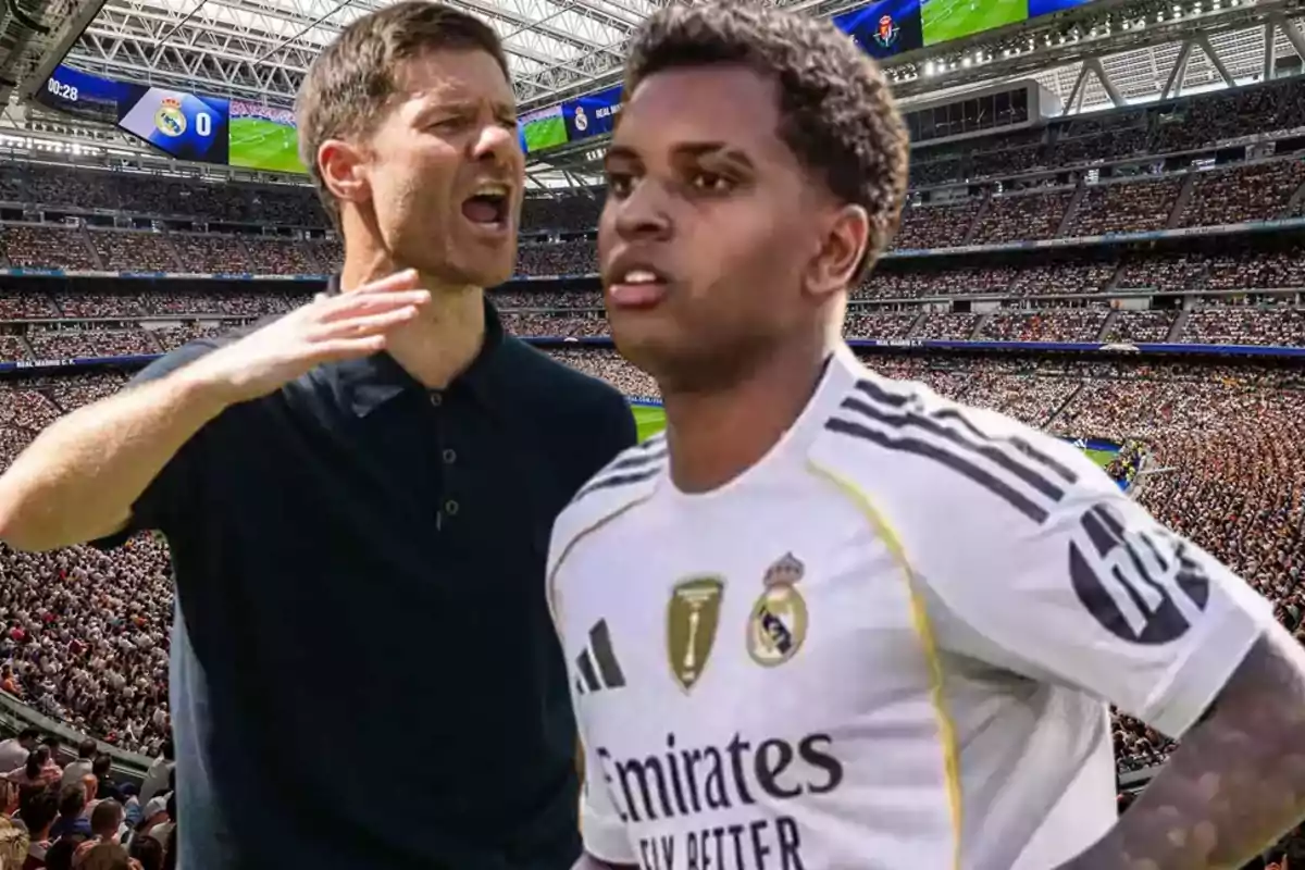 Coach giving instructions to a Real Madrid player in a packed stadium during a soccer match