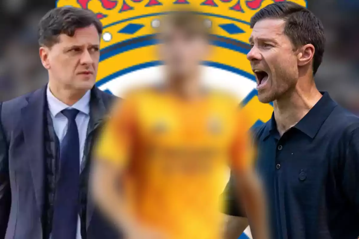 Two coaches and a player out of focus in the center with the Real Madrid crest in the background