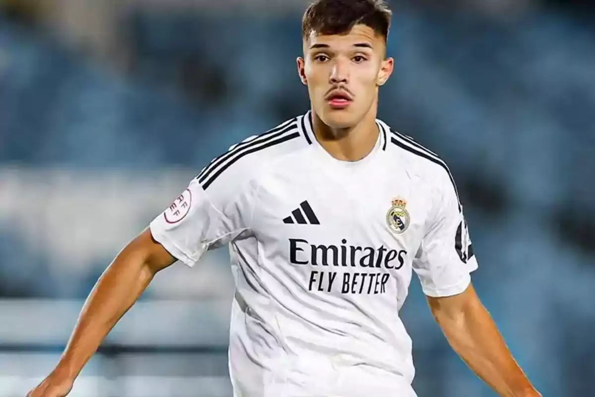 Soccer player in a white Real Madrid uniform in action during a match Soccer player in a white Real Madrid uniform in action during a match